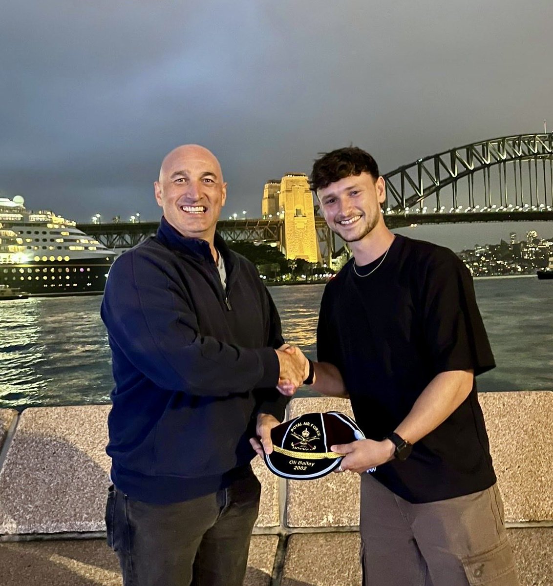 RAFHockey's tweet photo. Oli Bailey, received his RAF Cap from Jordan Oatley, during a presentation held on Sydney Harbour, Australia. Throughout his distinguished playing career, Oli won three Inter-Services titles in 2002, 2010 and 2012, and earning recognition as Player of the Inter-Services in 2007. https://t.co/wclmK65Sit