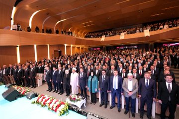 First image shows a man in a suit standing at a podium with a blue backdrop featuring Turkish flags and text in Turkish reading Imam Hatip Okulları Başarılı Örnekler Sergisi Ödül Töreni dated 17 EKİM İSTANBUL. Second image depicts a group of people including women in headscarves and men in suits gathered around a white vintage-style car with ornate designs and a banner reading KASIM 2023 DİN GENEL MÜDÜRLÜĞÜ İMAM HATİP ORTAOKULU in a modern building entrance. Third image captures a large audience of mostly men in suits seated in an auditorium with wooden architecture, banners, and flowers on stage. Fourth image shows a man in a suit presenting a trophy to young people including boys and girls in casual clothes and headscarves on a blue-curtained stage with microphones and awards.
