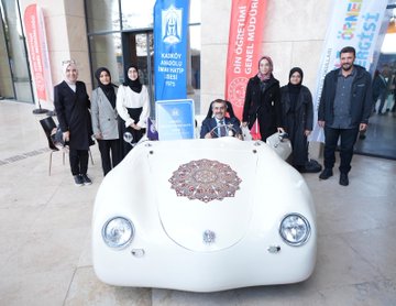 First image shows a large group of formally dressed men and women standing on a blue-lit stage holding awards during a ceremony with a banner reading Imam Hatip Basari Ornekleri Sergisi ve Odul Toreni and screens displaying participants. Second image captures several people including young individuals posing outdoors with a large red rocket model labeled ROCKET, a white drone, and flags in a courtyard setting. Third image features women in headscarves and men around a white vintage car decorated with intricate patterns and a plaque for Kizilay Imam Hatip Ortaokulu Din Geneli 1875 on a patterned floor. Fourth image depicts a man in suit interacting with two children one boy and one girl in headscarf seated in a blue racing simulator cockpit inside a metallic enclosure with screens and sponsor logos like Spar.