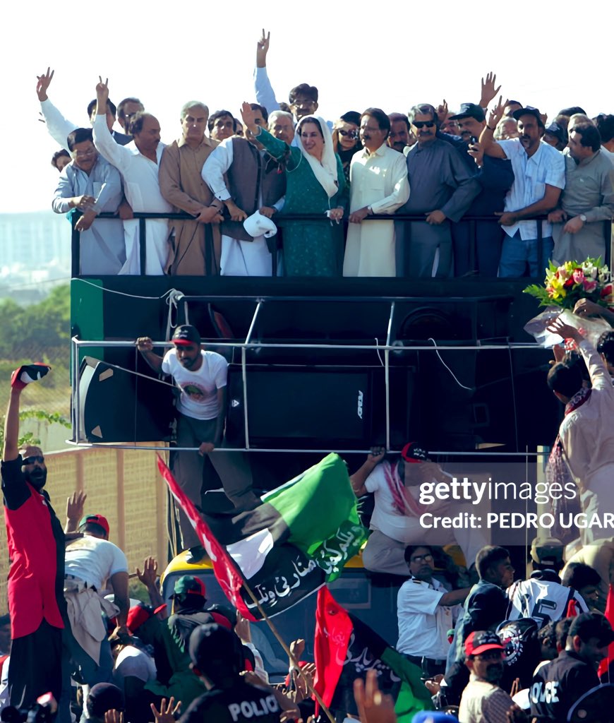 A_B_Raees's tweet photo. 18th October 2007 Archives: A Cherished Memory of My Father, Late #Hanif_Raees, Standing Proudly On the Truck of Our Fearless Leader, Shaheed Mohtarma Benazir Bhutto, While Fulfilling His Duty as a Devoted Janisar-e-Benazir. His Dedication to Democracy Will Always be Remembered. #SalaamShuhadaEKarsaz