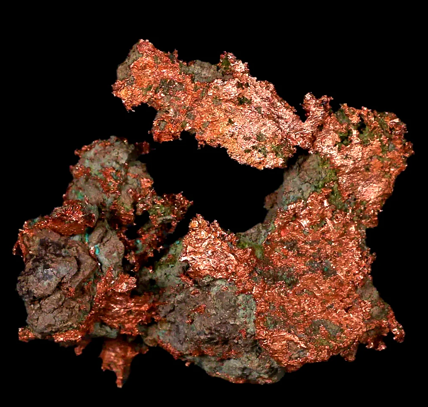 geologyBits's tweet photo. 🟥 ⛏️ Copper Ore Slab
from Keweenaw Peninsula, Michigan
This polished slab showcases a classic example of native copper ore from the historic Keweenaw Peninsula deposits.
❤️ 🔁 #KeweenawCopper #NativeCopper
🎞️ https://t.co/vZhVsWFWN3
▶️ Featuring irregular sheets and dendrites of metallic, reddish-copper native copper (Cu) embedded in a vesicular basalt matrix.
The specimen displays vibrant green epidote (Ca₂(Al,Fe)₃(SiO₄)₃(OH)) as fibrous or columnar crystals filling amygdules, alongside white to translucent patches of calcite (CaCO₃) or prehnite (Ca₂Al₂Si₃O₁₀(OH)₂) veins that exhibit rhombohedral cleavage and vitreous luster.
Dark greenish-black chlorite or altered basalt forms the groundmass, with subtle orange-red tinges likely from minor cuprite (Cu₂O) oxidation products.
The slab measures approximately 10-15 cm across, with a Mohs hardness ranging from 2.5 (calcite) to 3 (copper), and it polishes to a high sheen, highlighting the metallic luster of the copper against the contrasting textures of the secondary silicates and carbonates.
▶️ The native copper in this slab formed during the Mid-Proterozoic era around 1.06 billion years ago amid the rifting of the North American continent during the Midcontinent Rift event, when mafic basaltic lavas (Portage Lake Volcanics) erupted and flowed across the landscape, creating gas pockets (amygdules) and interflow conglomerates.
Hydrothermal fluids, likely hot basinal brines rich in copper leached from underlying sediments or volcanic sources, circulated through fractures and vesicles in the cooling basalt at temperatures of 150-250°C.
Upon encountering reducing conditions, pH shifts, or mixing with cooler meteoric waters, the solubilized copper precipitated as elemental metal, often with minor silver alloys, while siliceous and carbonated waters deposited associated gangue minerals like epidote and prehnite through metasomatic replacement.
Subsequent glacial and fluvial erosion during the Pleistocene exposed these deposits near the surface, enabling mining from the 1840s to the 20th century.