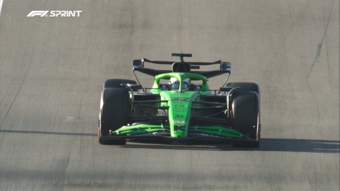 A green Formula 1 car, identified as Nico Hulkenbergs Williams based on post context, races on a track with motion blur on wheels and surroundings, featuring aerodynamic wings, sponsor logos, and F1 Sprint watermark in the corner.