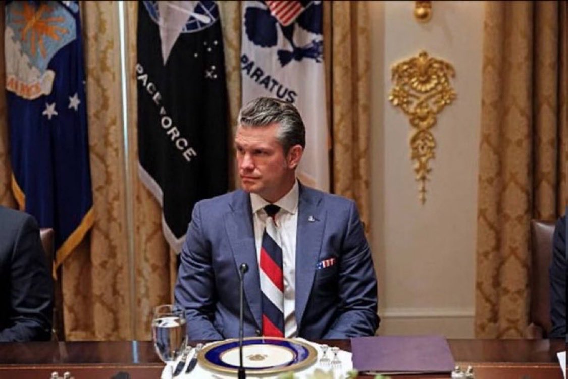 The US Minister of War with a tie representing a country that commits the most heinous crimes, including genocide against Ukrainian children. A supporter of imperialist Russia represents the USA. How sad.