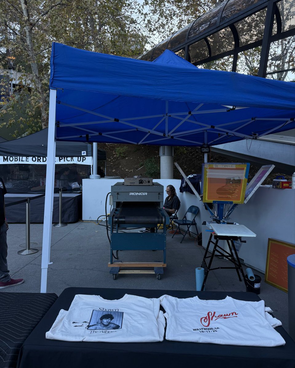 ShawnAccess's tweet image. The #ShawnOnTheRoadAgain vintage merch pop up and screen printing are back for our last show tonight. If you’re at #OnTheRoadAgainLA, head to the box office roof across from tour merch in front of Escalator 1 to get your favorite merch pieces from over the years, and get them…