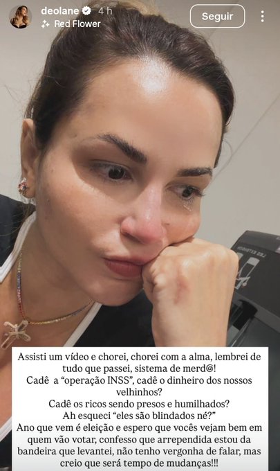 A woman with long dark hair and makeup wearing a light-colored top and necklace sits with her hand on her chin looking pensive. The background appears indoor and neutral. Text overlays include Portuguese phrases about watching a video that made her cry representing women from favelas or not and questioning if she has shame. An Instagram watermark is visible in the corner.