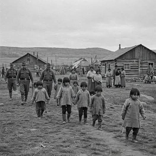 Does this look normal? Marching little kids to residential school.