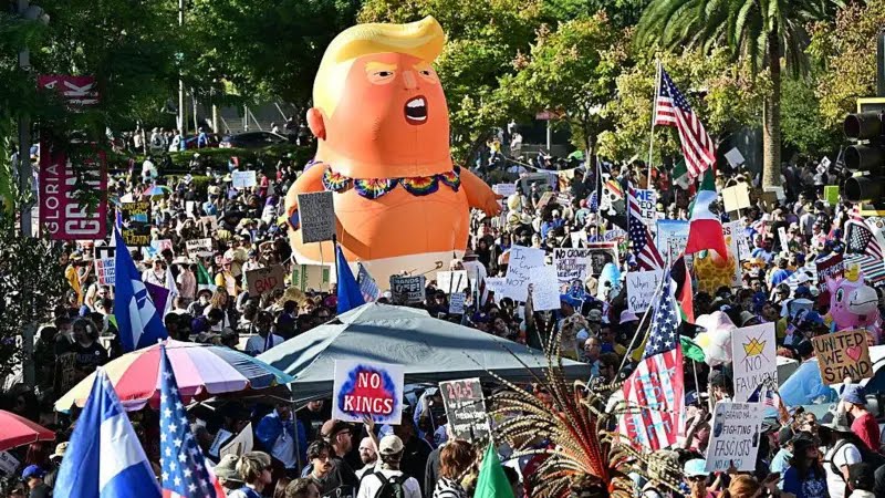 Fans_Bharat's tweet photo. #NoKings symbolizes a rejection of  authoritarian tendencies, emphasizing that America has no monarchs and power belongs to the people.

Protesters rallied against:

Domestic military deployments: Use of troops for crowd control and border enforcement.

Attacks on critics: Efforts to prosecute political opponents, journalists, and activists.

Federal government shutdown: Ongoing gridlock, blamed on Trump's agenda.

Foreign policy: Handling of tariffs, impacting everyday Americans.

Broader authoritarianism: Perceived erosion of civil liberties, free speech, and democratic norms.