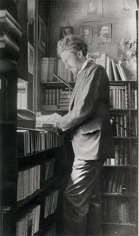 Ezra Pound browsing, possibly at Shakespeare and Co., Paris.