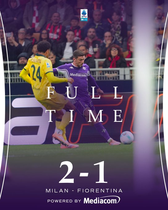 Player in purple jersey number 24 with Mediacom sponsor kicks soccer ball on green field near yellow goal net during match, another player in yellow jersey number 24 approaches from behind, stadium stands filled with cheering crowd in background, purple overlay text reads FULL TIME and score 2-1, bottom text Milan-Fiorentina powered by Mediacom.