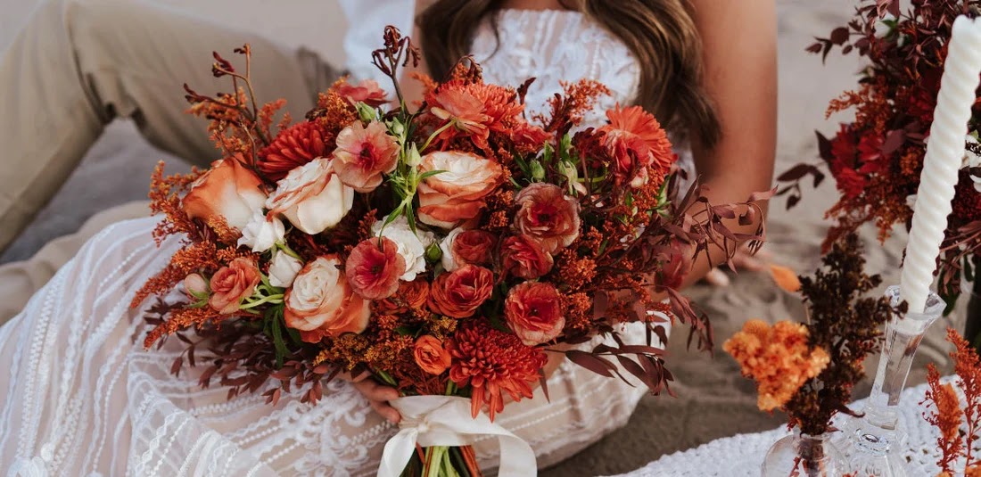 Late October is the perfect time for embracing fall colors. When it comes to floral bouquets and boutonnieres: go for deeper colors like burgundy, dark red, or rust with bronze/dried accents! 

Pic creds: Fifty Flowers