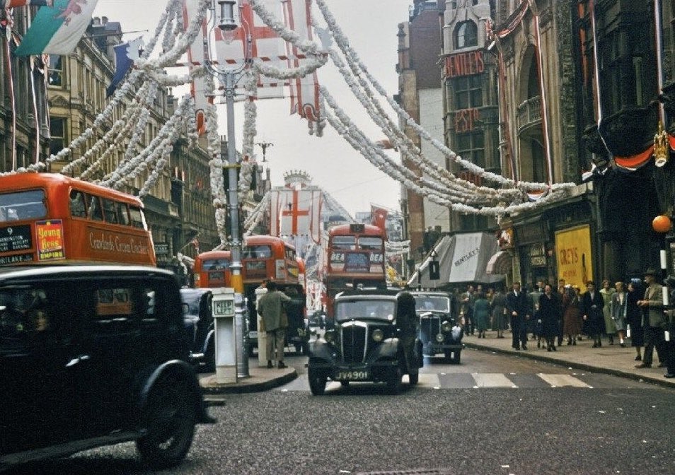 A magnificent photo of a street in London adorned with the Cross of St George. Taken in the 1940s.