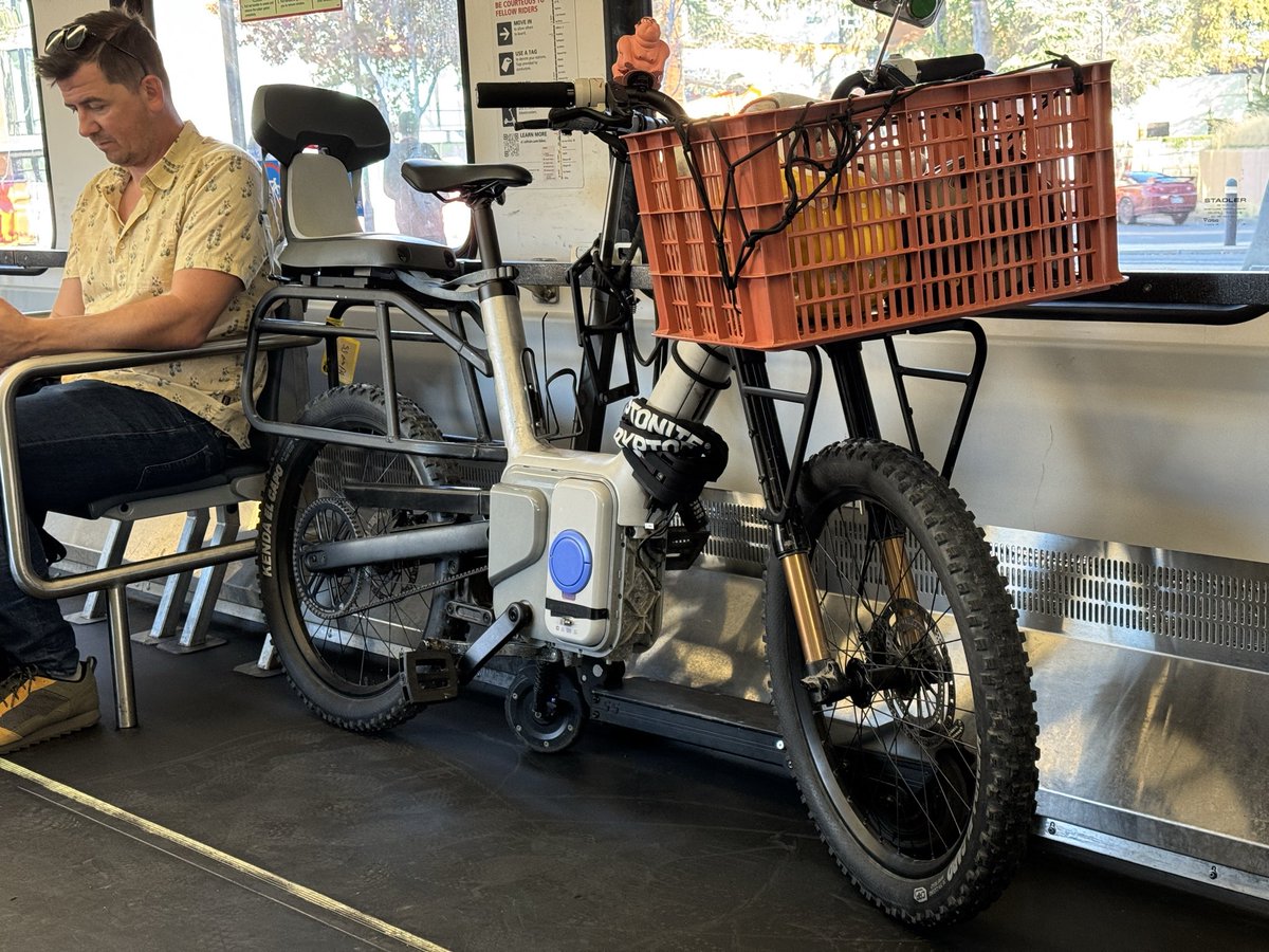 The secret upcoming e-bike from Rivian/ALSO just leaked… again. Thanks to Adem Rudin for sending me the pic after he spotted it on the Caltrain. I see a fascinating custom inverted cargo fork, sophisticated rear suspension, ABS on the front disc, small battery. What do you see?