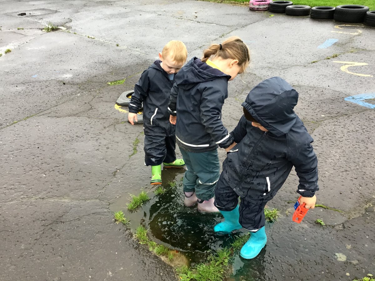 The children experimented with food colouring by adding to the puddles.