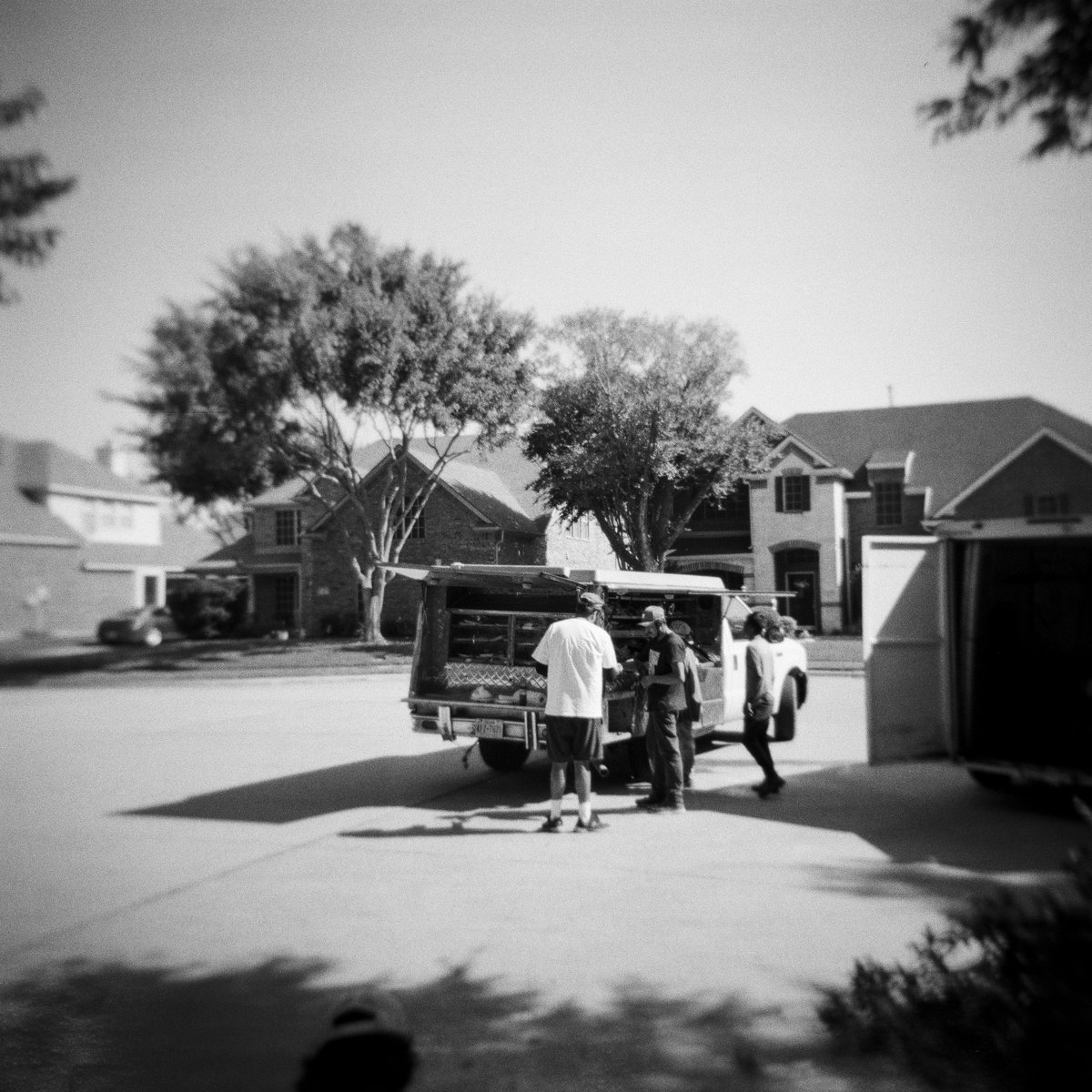 Somewhere at #HolgaManor with our tree trimmers and their lunch truck. Shot with my Holga 120GCFN on Kentmere 400 film for <a href="/HolgaWeek/">Holga Week</a> 2025.

#filmphotography #filmtography #holgaweek #holgaweek2025 #streetphotography #lunchtruck