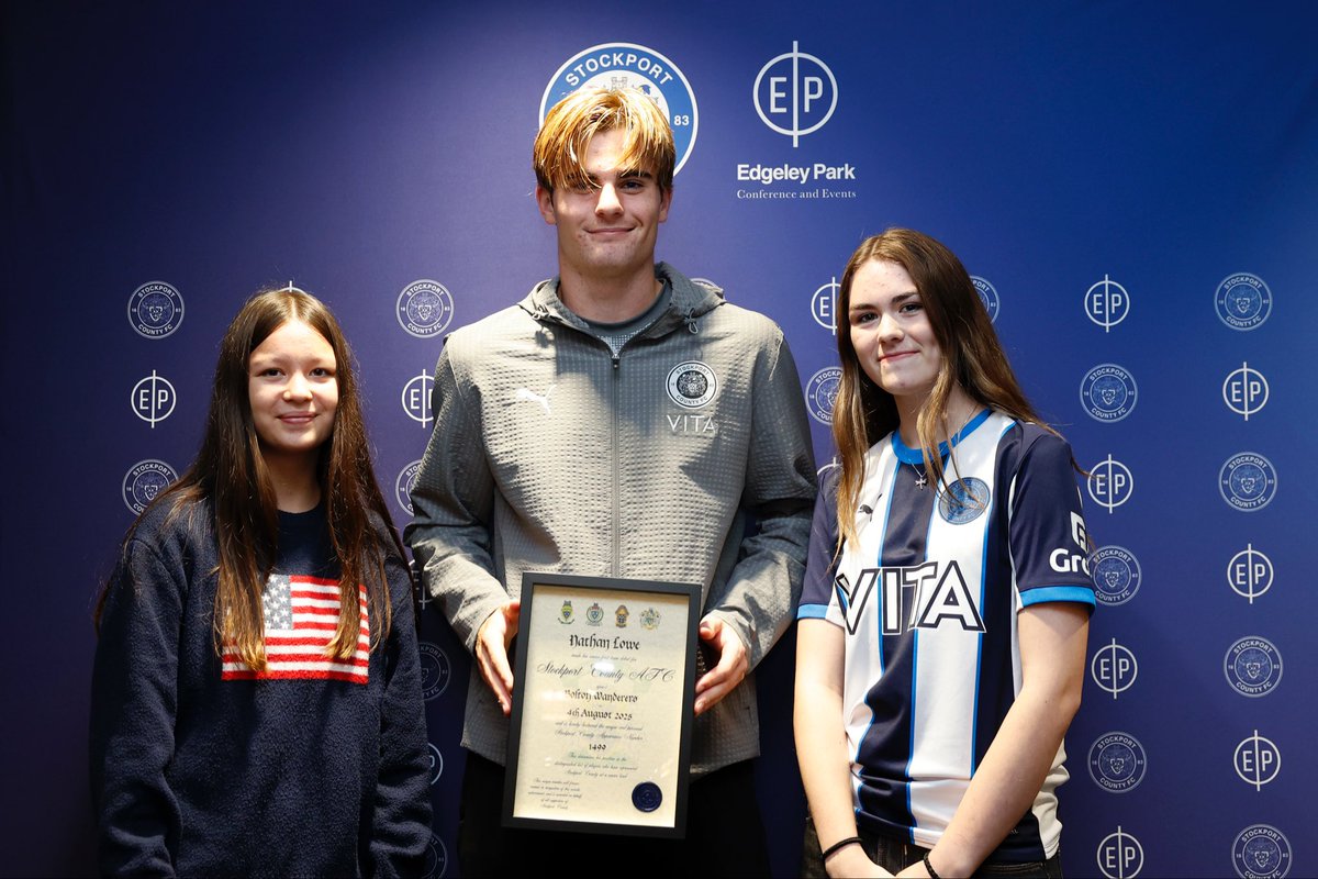 Nathan Lowe was presented with his certificate by Olivia Knowles and Charley Adams at Edgeley Park. 18/10/25. #StockportCounty  Photo: Mike Petch.