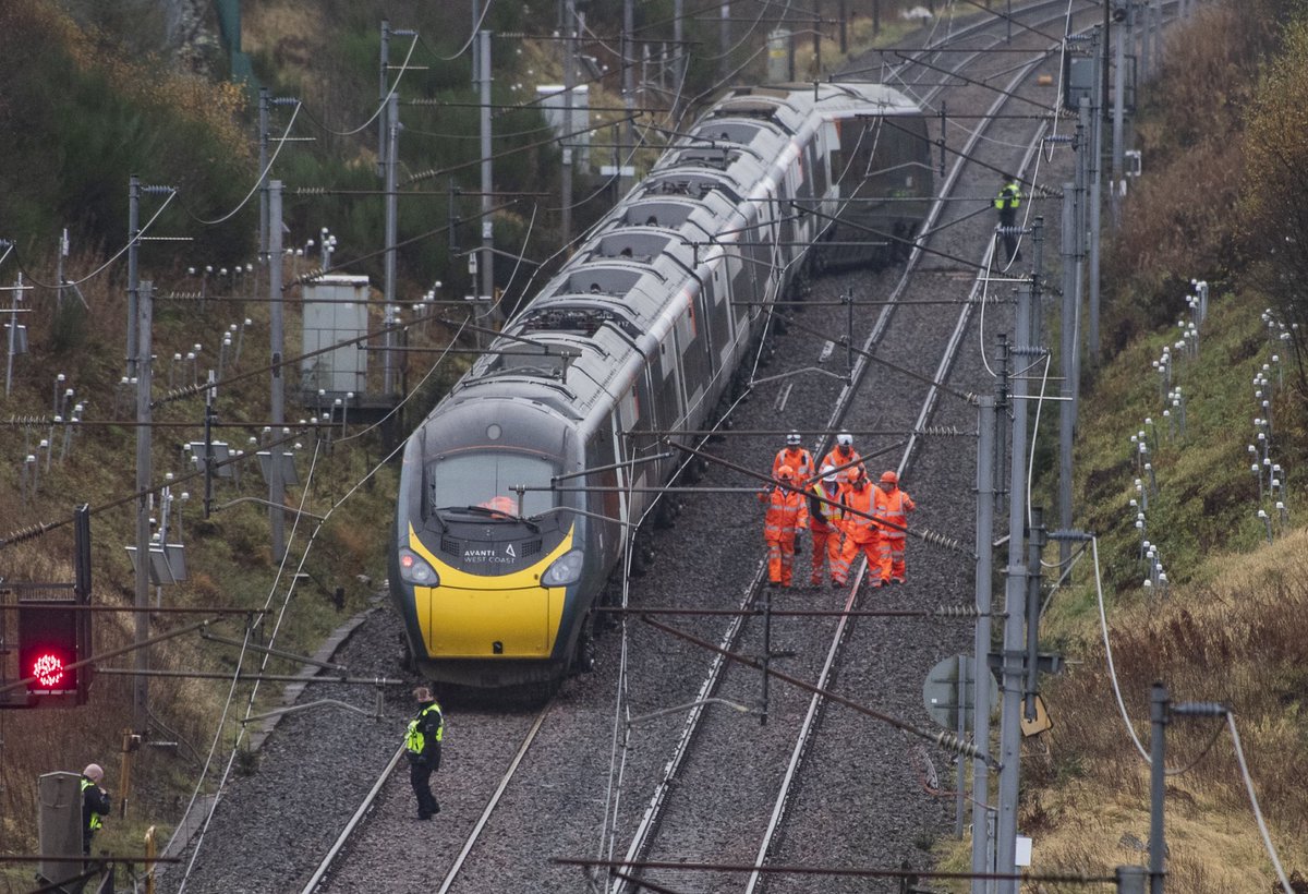 Network Rail workers alongside police on the scene of the train derailment near Shap, Cumbria this morning