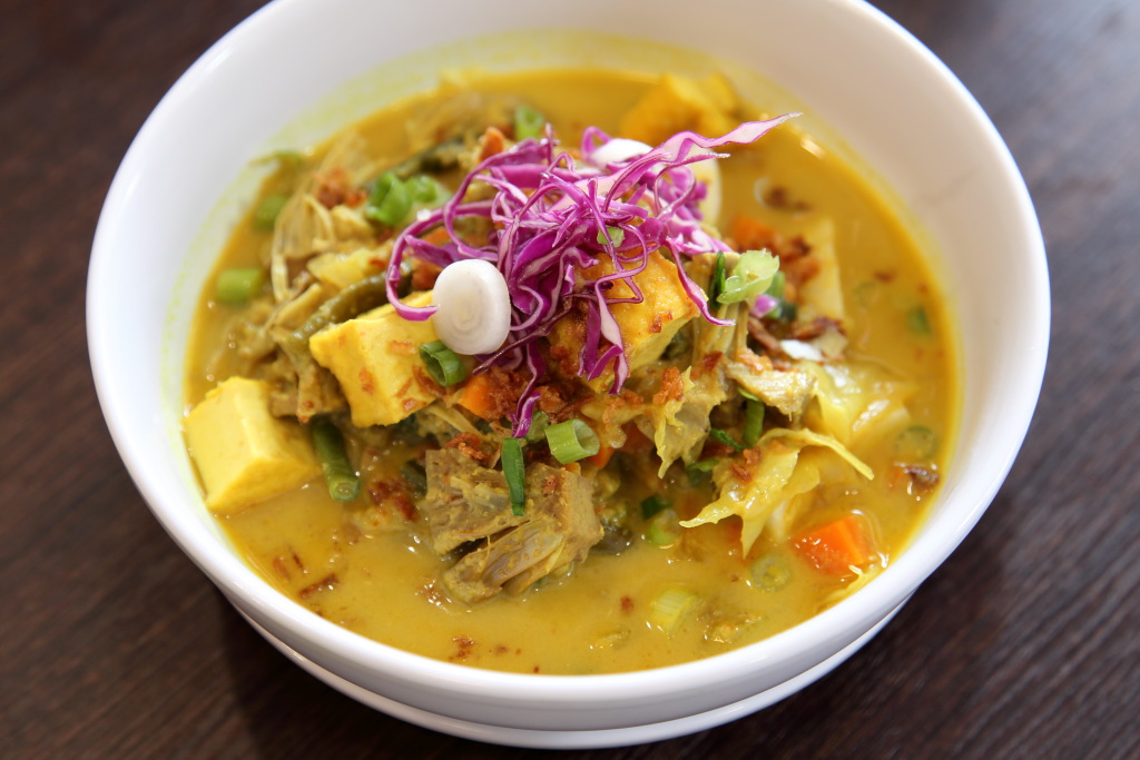 Beef rendang, lempur ayam, and lontong sayur, Indonesian dishes served to a gamelan soundtrack at tiny Indo Mix, Clinton Hill, Brooklyn