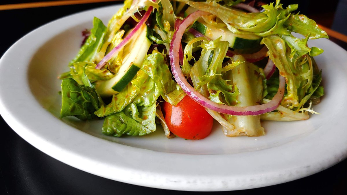 Craving a refreshing bite? Try our Mixed Greens Salad! 🥗 Packed with red onion, tomato, cucumber and drizzled with a divine roasted red pepper balsamic vinaigrette. It's freshness in every forkful! #SaladLovers #BarleyHouseTavern 🍅🥒