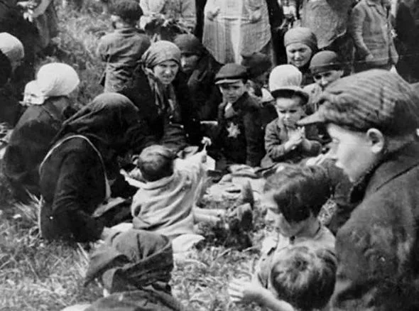 A young Jewish girl picks a dandelion and shows it to her friends as they wait near the gas chambers at Auschwitz-Birkenau in May 1944.  

One thing that is so tragic about the Holocaust is that so many people decided to stick around because they thought: "There is no way a