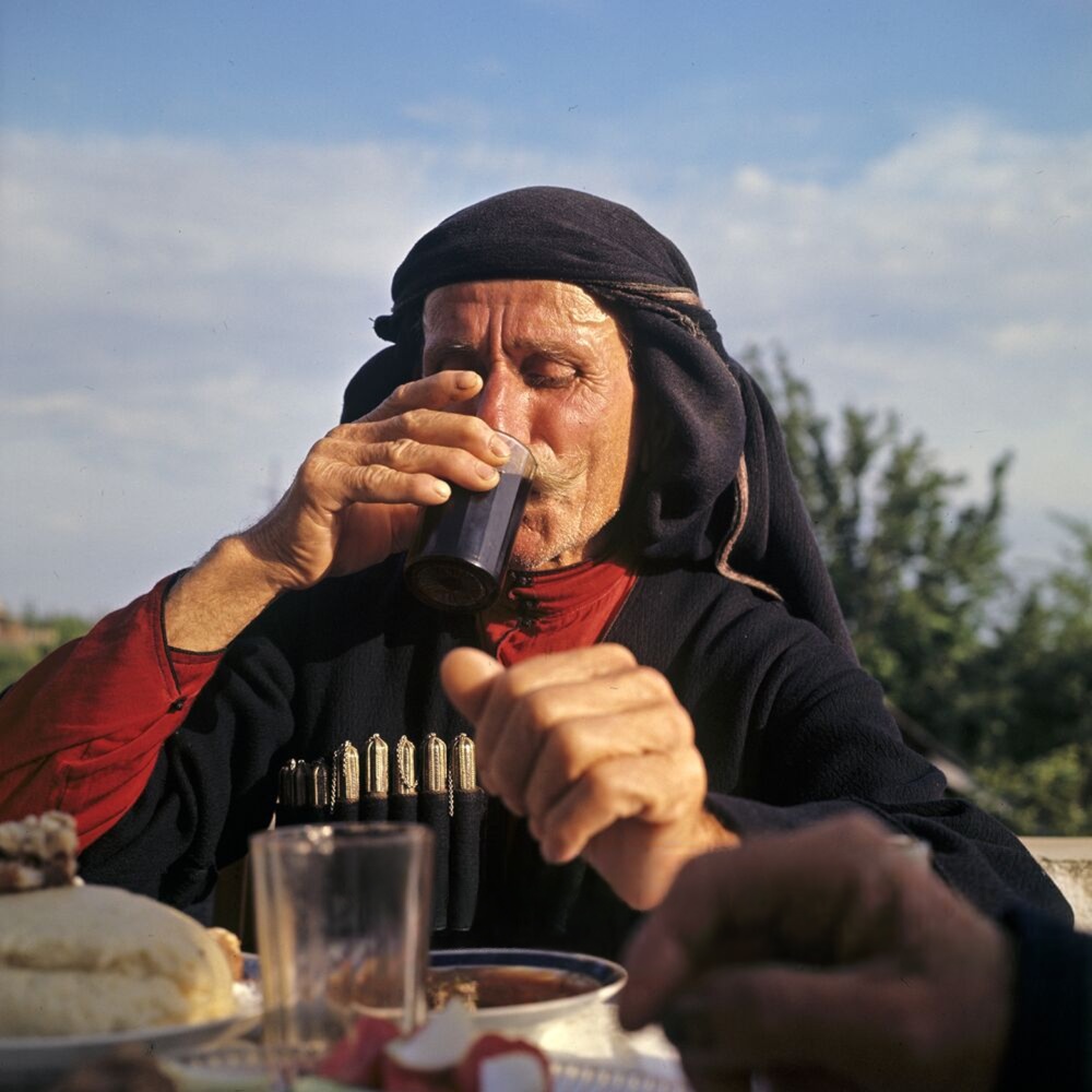 1. Abkhazian centenarians, the republic’s most honoured residents, on a stroll in the mountain village of Lykhny, Gudauta District, Abkhazia.
2. Centenarian highlanders at a traditional Caucasian feast. 
3. A centenarian highlander with a glass of his favourite drink, Isabella