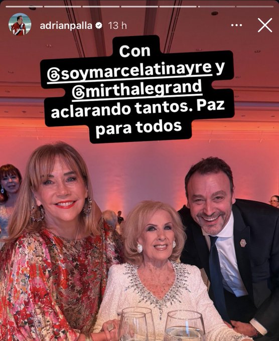 An Instagram post screenshot displays Adriana Palla in a colorful floral dress smiling on the left, Mirtha Legrand in a sparkling white outfit smiling in the center, and Marcelo Tinayre in a dark suit smiling on the right, all seated at a table with wine glasses during a formal event, with overlaid Spanish text reading Con @soymarcecelatinayre y @mirthaleggrand aclarando tantos. Paz para todos, and an Instagram watermark visible at the bottom.