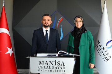First image shows a man in a dark pinstripe suit and white shirt signing a large open book with a pen at a desk, Turkish flags on either side, geometric wall backdrop. Second image depicts a man in a dark suit and a woman in a green coat and headscarf standing at a podium labeled Manisa Celal Bayar Universitesi, Turkish and white flags nearby, geometric backdrop. Third image features a group of eight formally dressed individuals, including men in suits and a woman in a green coat and headscarf, standing together at a podium with university logo, Turkish and white flags, geometric wall design.