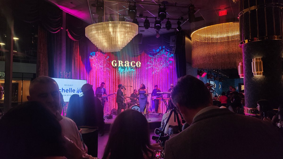 Supporters of Boston Mayor Michelle Wu's unopposed re-election campaign are getting ready to welcome her onstage at Seaport restaurant Grace by Nia while their jazz band performs. It's a packed crowd, as owner Nia Grace starts the evening.

Anna Hu for AsAmNews