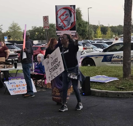 JeremyH418's tweet image. Might as well put cross hairs on their faces. 

The other side of the parking lot recited the Lord&apos;s prayer. 

The union, the teachers themselves, are aligned with the sign wavers.

Get your babies out of these schools. Now.

#jaxedu #jaxpol