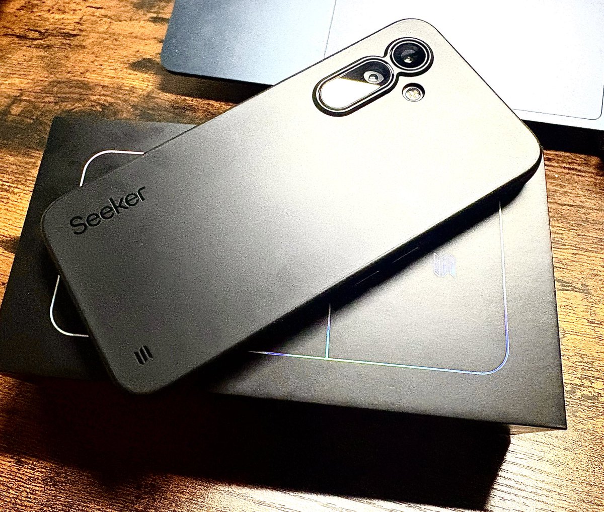 Unboxing the sleek black Solana Seeker phone from its premium packaging
