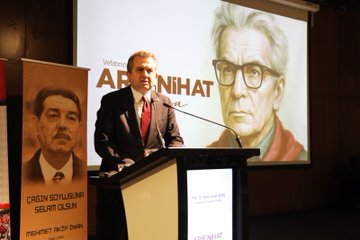 First image shows a man in a dark suit speaking at a podium with microphone in a conference room featuring banners for Turkiyenin En Buyuk Sendikasi and Arif Nihat Asya Nihai Asya alongside the Eğitim-Bir-Sen logo and a screen displaying Vefatının 50 Yılı. Second image depicts a man in a suit at a podium with a large projected portrait of Arif Nihat Asya wearing glasses and a red tie next to banners for Ercan Solusan and Arif Nihat. Third image captures a man in a gray suit speaking at a podium with Turkish and another flag banners for Turkiyenin En Buyuk Sendikasi and Eğitim-Bir-Sen plus a portrait of Arif Nihat Asya and text for Çukurova Solusan Mehmet Akif. Fourth image displays a large group of people including men and women in formal attire standing on a stage with a Turkish flag table with cups and microphones in a hall setting.