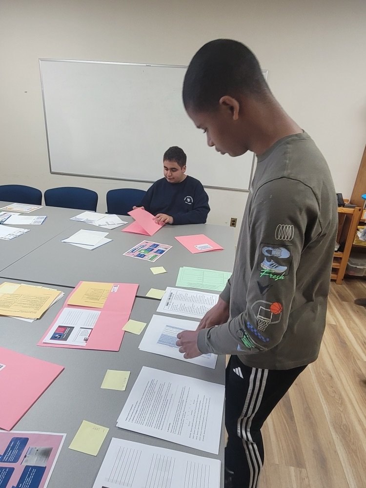 ACCESS Students preparing folders for Professional Development Workshops in the Northern Valley Curriculum Center.