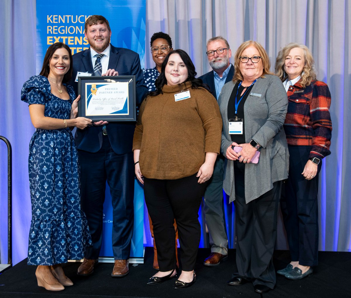 KentuckyREC's tweet photo. @KentuckyREC 's Megan Housley presents the Premier Partner Award to @KYRuralHealth 's Matt Coleman, Medina Tipton and team! #KYTransform #GuidingHealthcareImprovement #AnnualConference #KORH #KentuckyOfficeOfRuralHealth #QualityImprovement #HIPAA #PromotingInteroperability https://t.co/T5rdWdPDGV