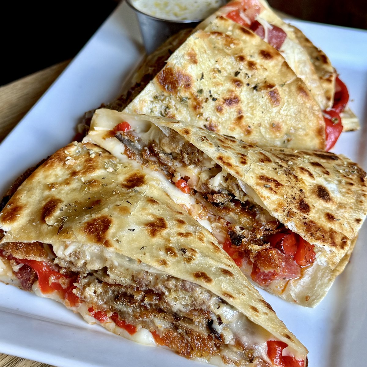 Another weekend special at Little Pub! 
The ah’Beetzadilla* - Meatballs, mozzarella, pepperoni, parmesan, breaded eggplant, tomatoes and roasted peppers all grilled in an herbed flour tortilla and served with a sidecar of pesto aioli 
*there are no beets in the ah’Beetzadilla.