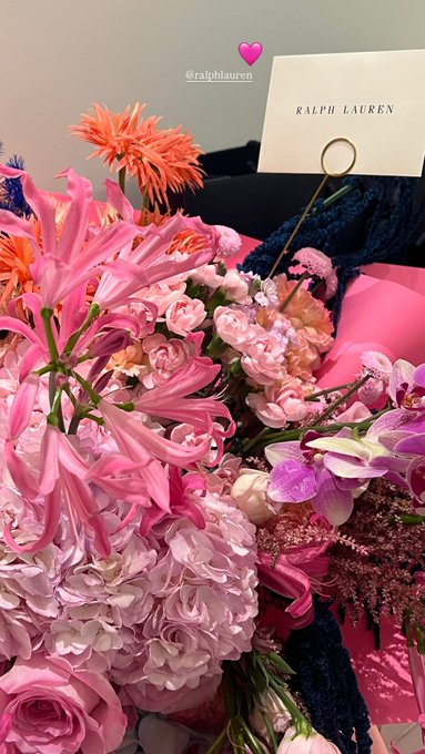 First image shows a clear glass jar filled with dog treats labeled Bacon and Nutty with a pink and yellow wrapper, a free sticker saying only if you are a dog, placed on a windowsill with a plant and dog emoji filter. Second image depicts two women taking a selfie in a luxurious bathroom with gold accents and mirrors, one with dark hair in a black top and jeans, the other with glasses in a white top and brown jacket, holding a pink phone. Third image features a vibrant bouquet of pink roses, orange lilies, and other flowers in pink wrapping with a Ralph Lauren card on a dark surface. Fourth image displays a bouquet of white roses and greens in white wrapping with a green birthday card in Korean text including Happy Birthday.