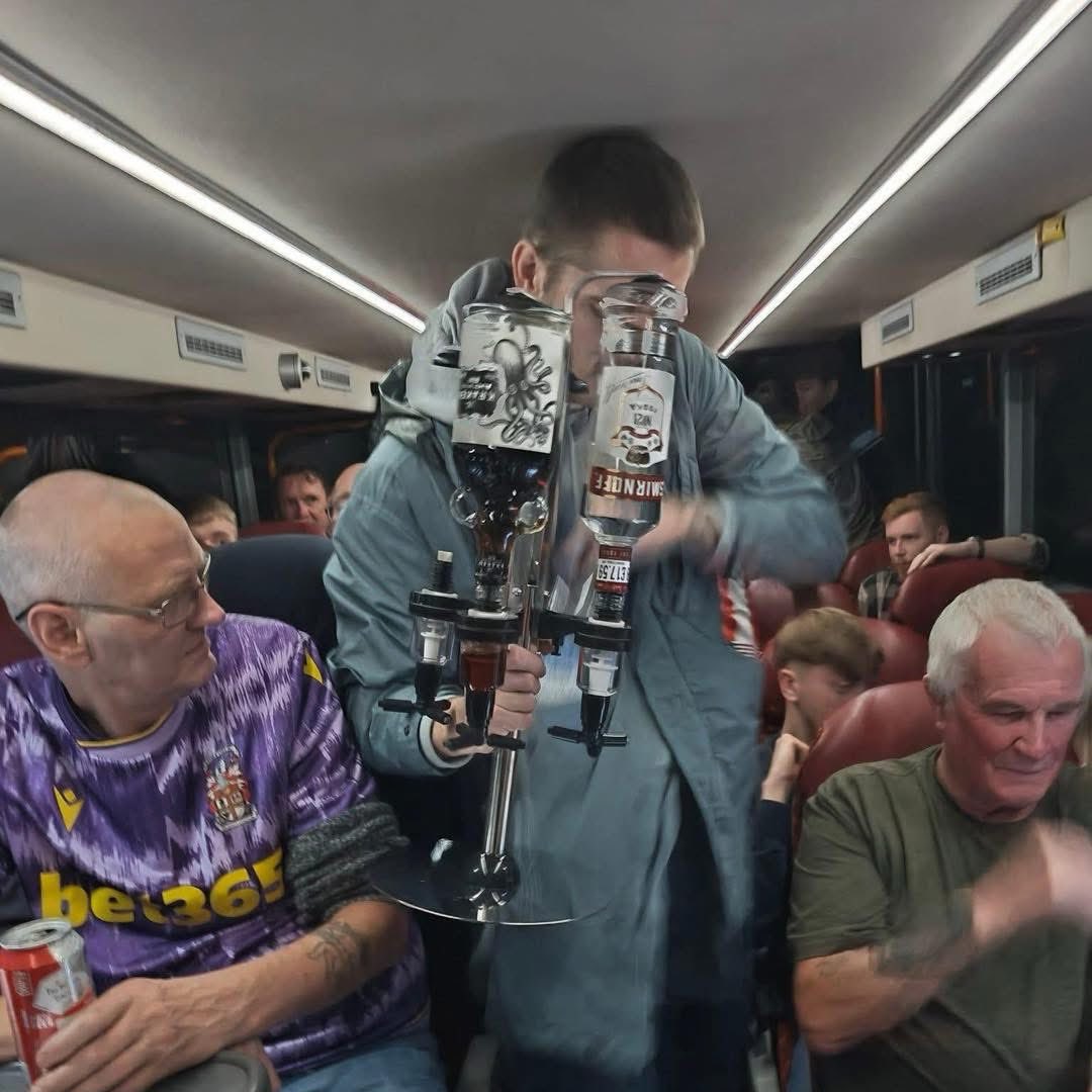 AwayDays_'s tweet photo. This Stoke City fan isn’t messing around on the 5am coach down to Portsmouth this morning. 

 Look at the blokes face next to him 😂🍻 https://t.co/BvV8YwHMuH