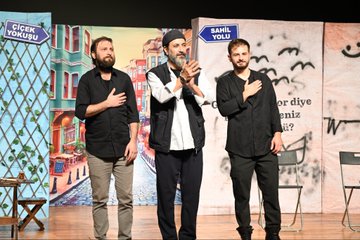 First image shows a large group of men in suits and formal attire standing on a wooden stage with blue backdrop banners displaying text like BEUN and event names surrounded by green plants and white flowers at the edges. Second image depicts a crowded auditorium filled with audience members seated in blue chairs facing a stage with wooden floor and floral decorations. Third image captures three male performers on stage one with a beard holding a microphone another in traditional vest gesturing with hand on chest and the third standing nearby with backdrop banners reading SAMİL YOLU and CİĞER. Fourth image features three actors in a scene one with beard in white shirt and vest another in black shirt touching shoulder and the third in black top sitting at a table with chessboard and chairs against backdrops with Turkish text like BİR İNSAN KALBİMDE BİR and VEFA CİĞER.