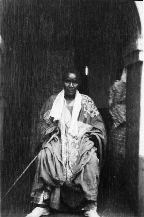 OziIkoro's tweet photo. Titled Igbo man photographed by Gustaf Bolinder, 1930–1931.

Seated at a building entrance, he wears richly embroidered robes and holds a staff, symbolising prestige and authority among Igbo titled men. https://t.co/nLxrXO5GIT