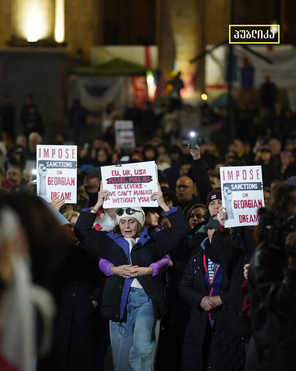 This photo was taken in front of the Georgian Parliament.
The woman in front was just released after spending days in prison  her only “crime” was blocking a road in peaceful protest. The woman behind her is holding her tightly, because if she dares to block the road again, she