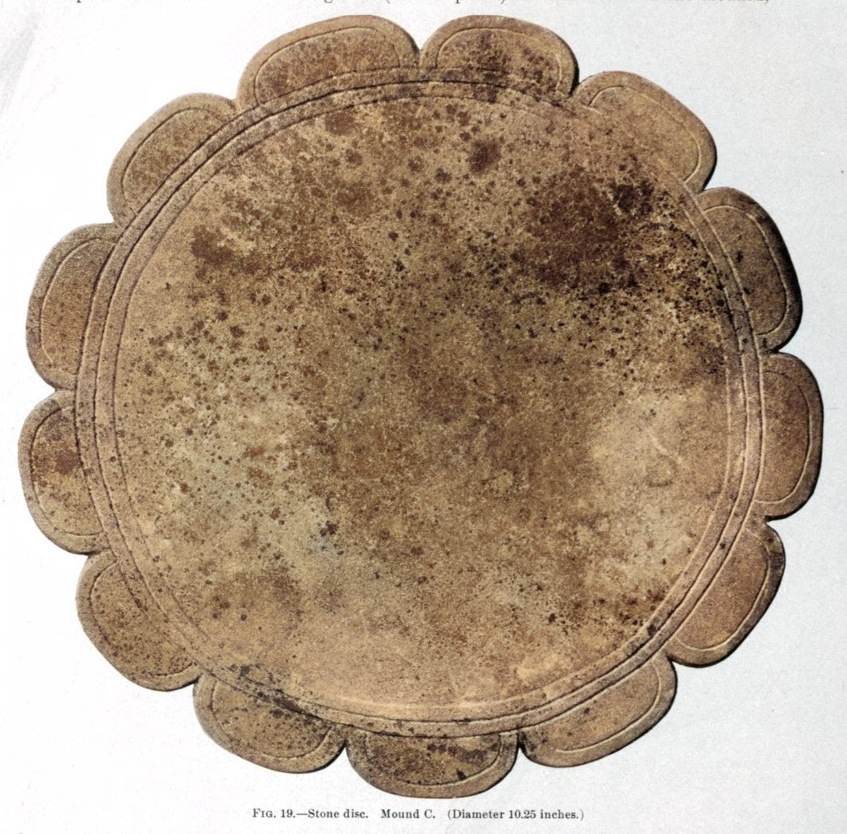 Stone discs excavated from mounds at Moundville, Alabama by C. B. Moore in the early 1900s. They are about 10-13 inches in diameter.