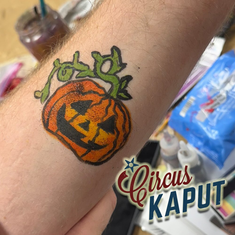 That time we practiced using black glitter for Halloween events! Art by Evan. 🎃 We are using that glitter now! #circuskaput #halloween #facepainting #armpainting #stlouis
