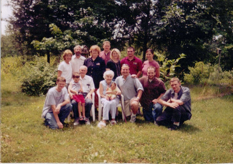 Family picture taken by cousin shortly after my daughter had her second child, being held by my mother in center, with her 5-yr old being held by my dad. Two sisters, my brother, all three of my children, my older sister's three boys, and my younger sister's son.