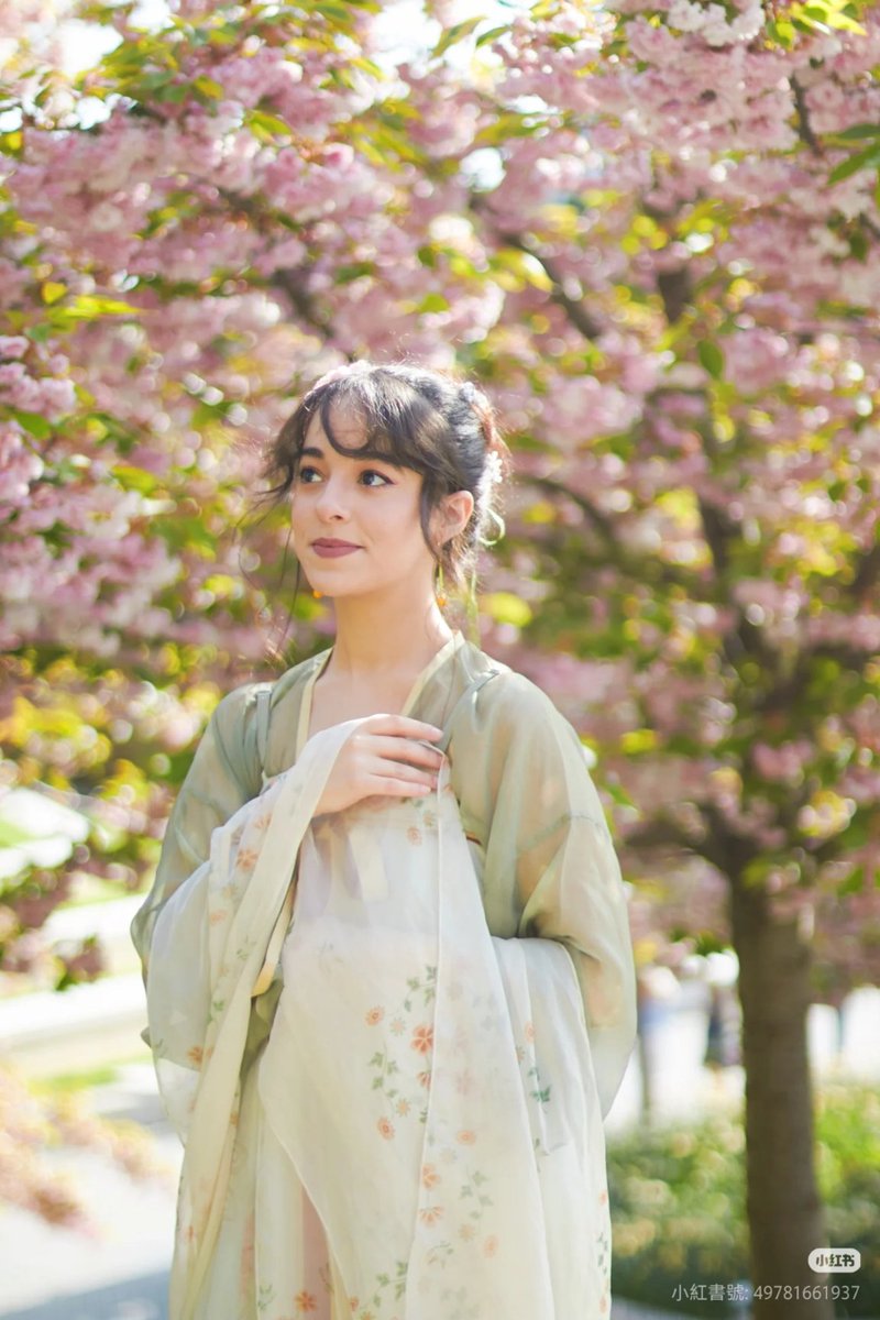 A girl stands smiling among blooming flowers, dressed in Tang Dynasty style #Hanfu for the very first time. With gentle sleeves and delicate hairpins, this is how heritage finds new life in everyday moments. 
#CulturalMoment (Via. Imane)