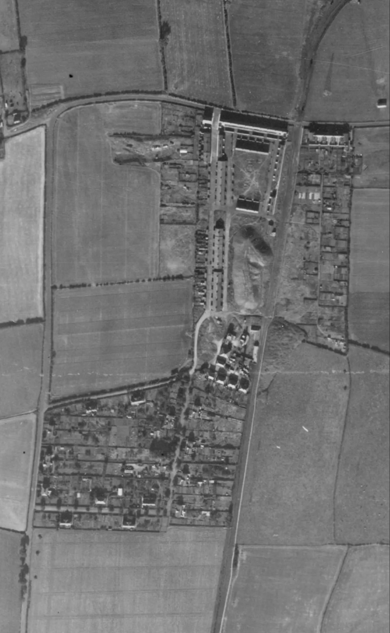 The site of the Coronation Pit, with its legacy pit village and heap, in 1947. 

Source: Historic England Archive (RAF photography)    raf_cpe_uk_2352_fs_2132 flown 4 October 1947
