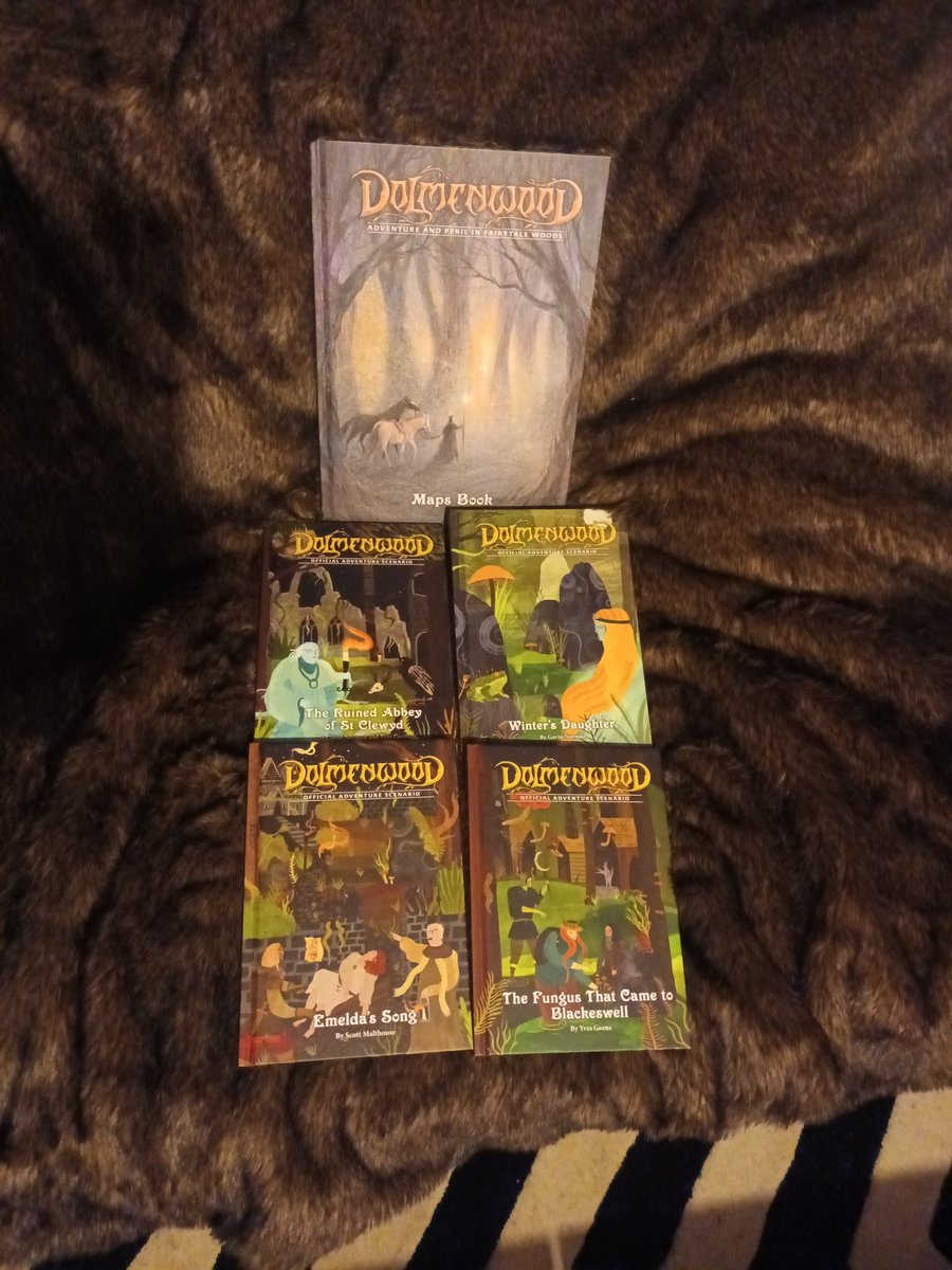 JacobOdd1's tweet photo. I did go for one of the higher tiers, so the hardback rulebooks came in a faux leather sleeve with a great goat (Breggle) silver inlay, a cloth map and four small hardback adventures (reminiscent of childhood Ladybird fairytale books). https://t.co/nvdKLVrD34