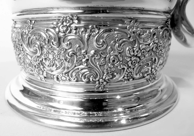 Sterling silver tankard by Tiffany &amp; Co., c. 1884. Hinged double-domed cover with split scroll thumb rest; s-scroll handle, &amp; stepped foot. Olden Days Georgian prettified with chased band of flowers, diaper, &amp; leafing scrollwork. Fully marked . Item#CC386

nelsonandnelsonantiques.com/items/1509594/…