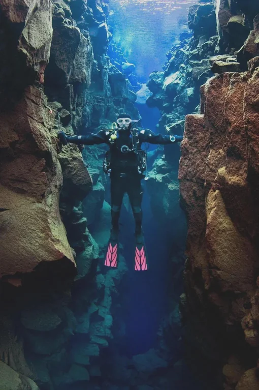 Touching North American and Europe at the same time.

If you dive into the Silfra fissure in Iceland, you are actually diving between two continental plates.