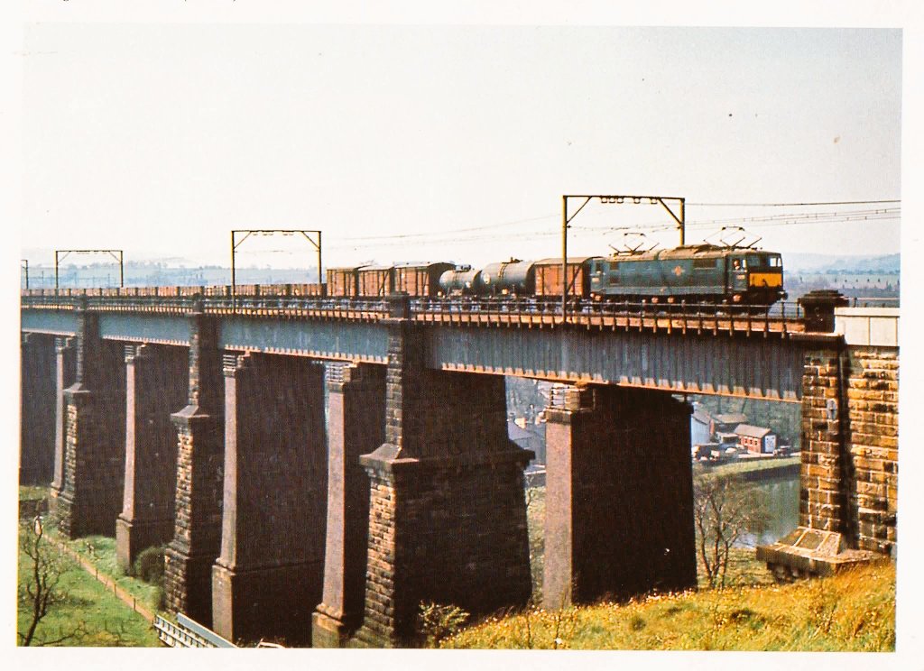 In April 1966 Class EM1 No. 26028 enters Dinting over the viaduct with a freight heading towards Woodhead. 

The extra strengthening piers can be clearly seen supporting the viaduct.
© B.Magilton