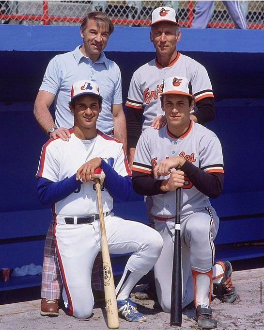 Cal Ripken Jr. with father Cal Ripken Sr and Terry Francona with father John Tito Francona during spring training. FL 1982 Photo by Ronald C. Modra This was taken during Cal Ripken Jr.'s Rookie of the Year season.