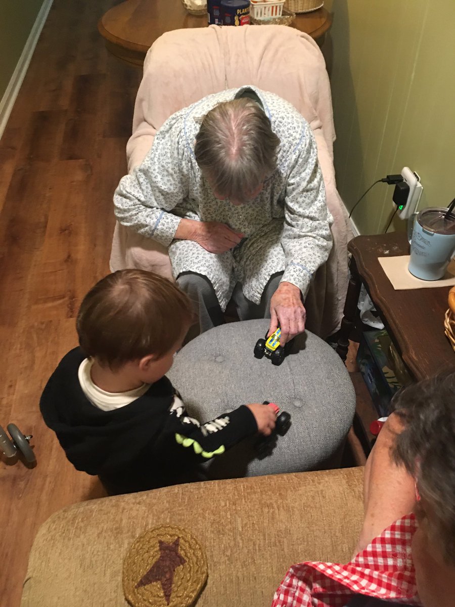 My nineteen month old grandson playing “monster trucks” with his 98 year old great-grandmother. Elderly are blessed by contact with children.