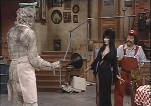 The scene then cuts to Elvira and Mario at Mario Brothers Plumbing, regarding the zombiefied Luigi.